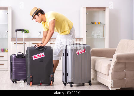 Man going on vacation with fragile suitcases Stock Photo