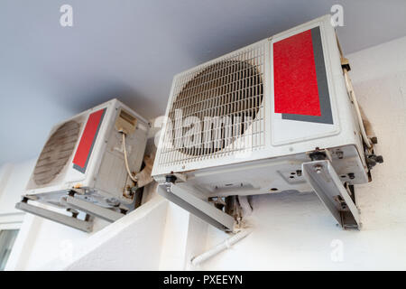 Two air conditioner hangs on a white wall Stock Photo