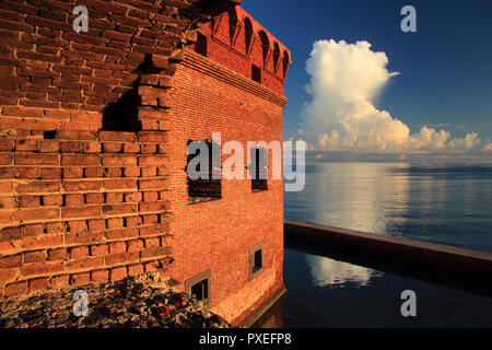 Thunder clouds burst over Dry Tortugas National Park, as viewed through one of the casemates of the mighty Fort Jefferson, located in the Florida Keys Stock Photo