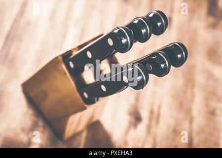 Macro Of A Kitchen Knive Block With 6 Knives On A Table, High Angle View Stock Photo