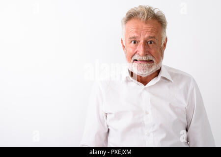 Close up of senior bearded man looking angry against white backg Stock Photo