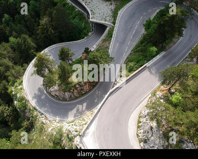 Aerial view of boundless forest and a Mountain Road in Austria Stock Photo