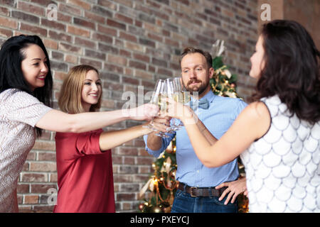 Young people clinking with champagne glasses at New Year's party Stock Photo