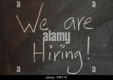 We are hiring written on blackboard Stock Photo