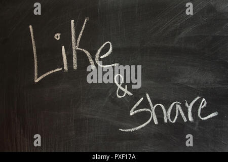 Like and share written on chalkboard Stock Photo
