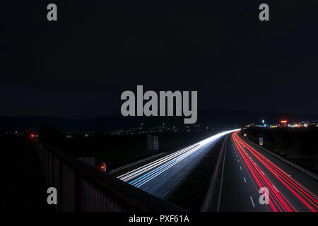Speed Traffic - light trails on motorway highway at night, long exposure abstract urban background Stock Photo