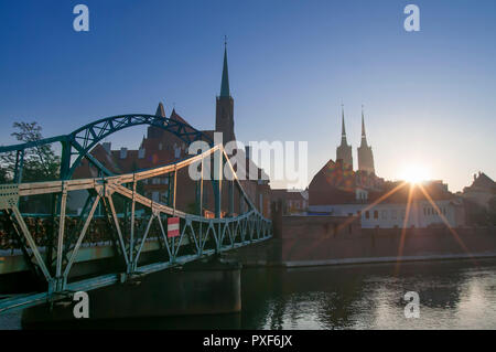 Tumski Bridge and Cathedral of St. John the Baptist twin towers on Ostrow Tumski. Odra river sunset Wrocław, Poland 2018 Stock Photo