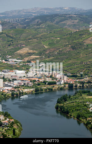 patterns of vines in vineyards in the Alto Douro Port Wine region of Portugal in Summer looking towards the area of Peso da Regua and river Douro Stock Photo