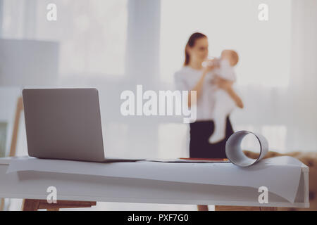 Silver modern laptop standing on office table in light room Stock Photo