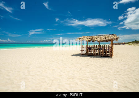 Awesome beach of Varadero during the day,in the middle a wooden and straw tent for massages on the beach, Varadero Cuba. Stock Photo