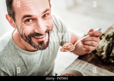 Delighted cheerful handsome man smiling to you Stock Photo