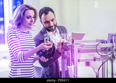Couple of creative software developers feeling busy working hard in the office Stock Photo