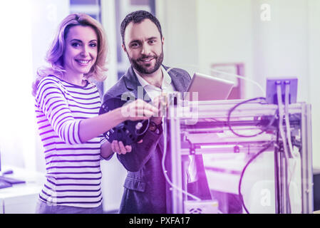 Couple of modern programmers feeling excited while working in their new office Stock Photo