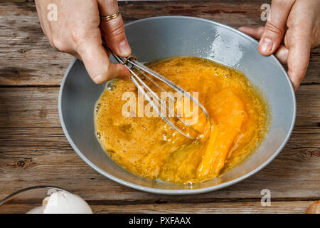 baker whipping eggs. preparation of dough.close up Stock Photo