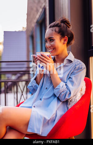 Joyful positive Asian woman enjoying her morning Stock Photo