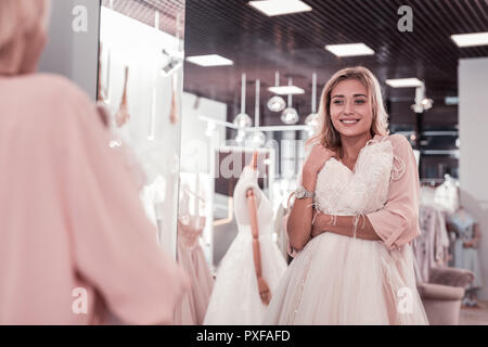 Nice young woman looking at her reflection Stock Photo
