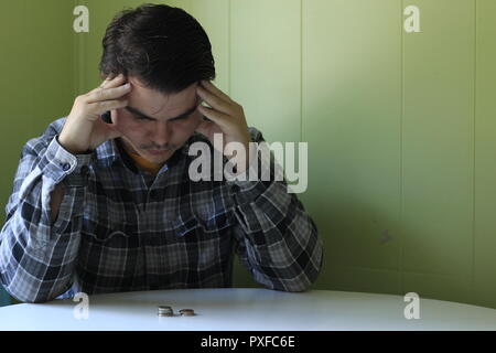 Thoughtful serious young man lost in thoughts in front of laptop, focused businessman or absent-minded student thinking of problem solution, worried p Stock Photo