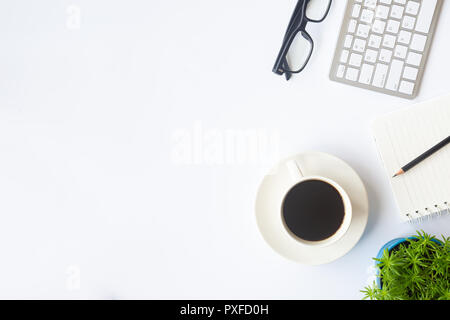 White desk office with laptop, smartphone and other work supplies with cup of coffee. Top view with copy space for input the text. Designer workspace  Stock Photo