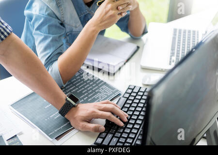 Asian team Outsource Developer Looking Screen Programming Code Working with Laptop Computer Software Stock Photo