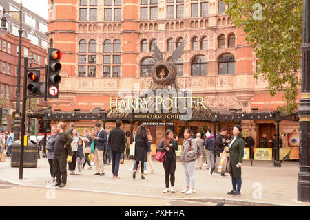 Signs advertising Harry Potter and the Cursed Child and a busy street scene outside the Palace Theatre, London, England Stock Photo