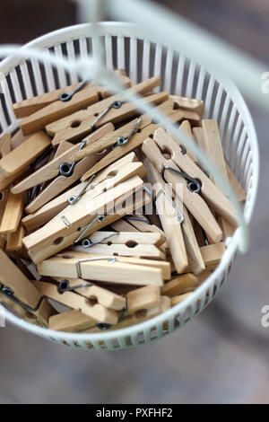 Wooden clothespins in the basket, blur, bright photo. The concept of eco-consumption, the use of natural materials, awareness. Stock Photo