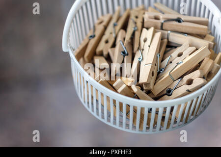 Wooden clothespins in the basket, blur, bright photo. The concept of eco-consumption, the use of natural materials, awareness. Stock Photo