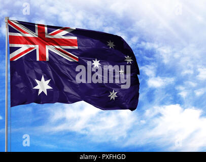 National flag of Australia on a flagpole in front of blue sky. Stock Photo