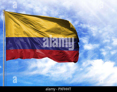 National flag of Colombia on a flagpole in front of blue sky. Stock Photo