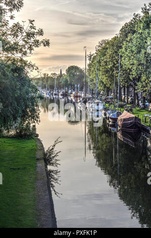 Edam, The Netherlands, October 7, 2018: yachts and historic barges moored at Nieuwehaven canal and reflecting in the still waters on a day in autumn Stock Photo