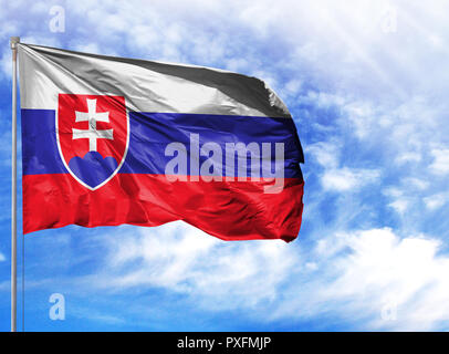 National flag of Slovakia on a flagpole in front of blue sky. Stock Photo
