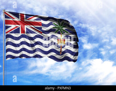 National flag of British Territory in the Indian Ocean on a flagpole in front of blue sky. Stock Photo