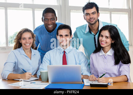Portrait of group of multi ethnic international business men and women at office of startup company Stock Photo