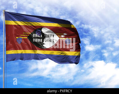 National flag of Swaziland on a flagpole in front of blue sky. Stock Photo