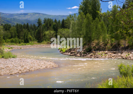 Blue Sky, White Clouds, River Splashing, Flowing Over Rocks. Sunny Summer Day. Ivanovskiy Khrebet Ridge, Altai Mountains, Kazakhstan.  Tilt-Shift Arti Stock Photo