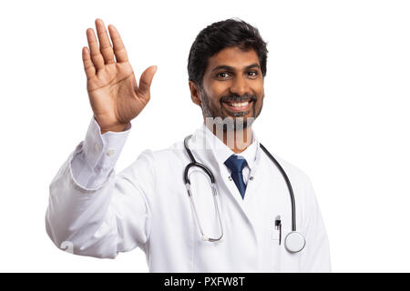 Friendly indian medic waving hand  smiling with cheerful expression isolated on white studio background Stock Photo