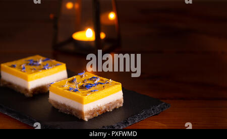 homemade lime and mango cake on a black stone plate Stock Photo