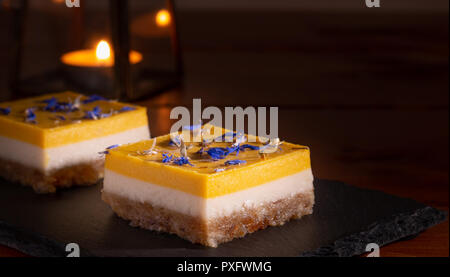 homemade lime and mango cake on a black stone plate Stock Photo