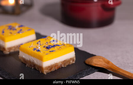 homemade lime and mango cake on a black stone plate Stock Photo