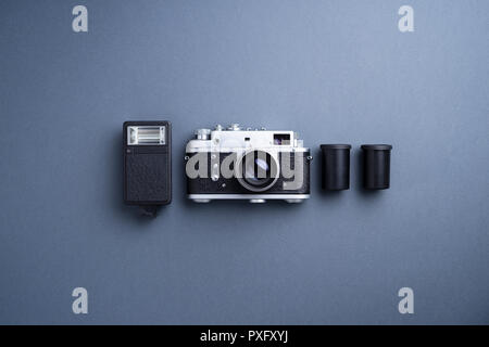 Analog camera and other accessories over gray background Stock Photo