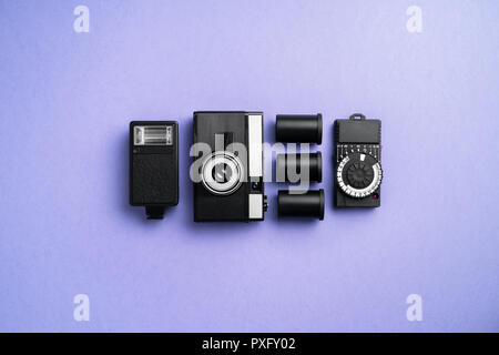 Analog camera and other accessories over blue background Stock Photo