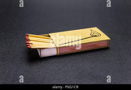 Long matches lying in a matchbox on a black background, with a clipping path. Stock Photo