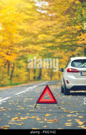 Broken car concept, breakdown triangle on road Stock Photo