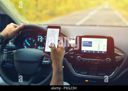 Male driver using smartphone to call 911 Emergency Number, while driving Stock Photo