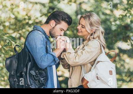 romantic man kissing girlfriends hand in autumn park Stock Photo