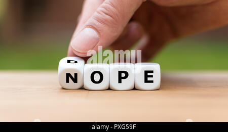 Hand is turning a dice as symbol to say no to drugs Stock Photo