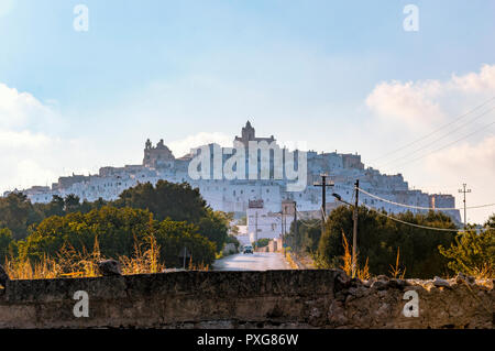 Panoramic shape of the medieval white village of Ostuni at sunset Stock Photo