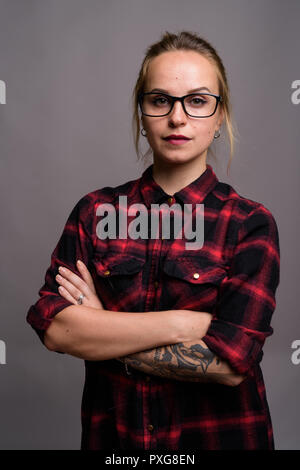 Young beautiful woman with blond hair wearing eyeglasses against Stock Photo