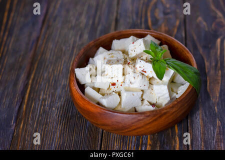 Ricotta cheese cubes in a wooden plate Stock Photo