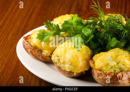 Baked potato with cheese and herbs Stock Photo