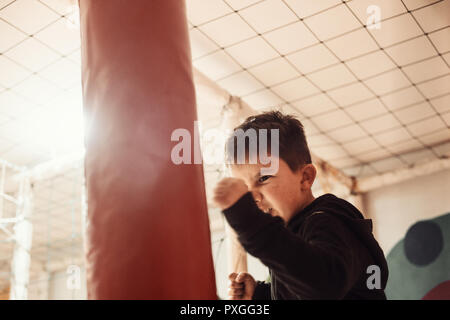 Close up little boy boxing and looking fierse Stock Photo